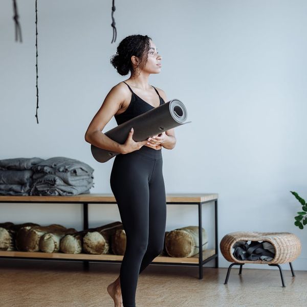 Woman in a serene meditation pose in a calm studio.